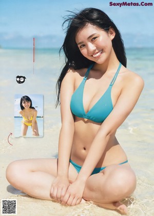 A woman in a white bathing suit standing in the water.