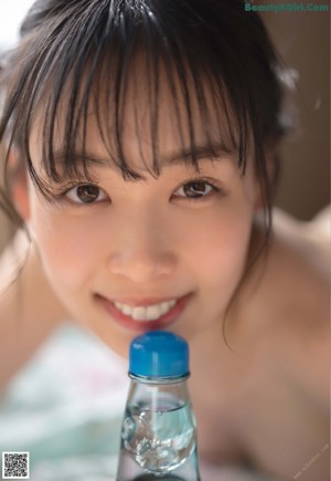 A woman in a blue shirt and plaid skirt posing for a picture.