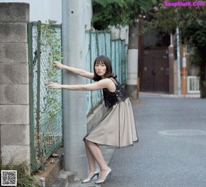 A woman with long black hair on the cover of a magazine.