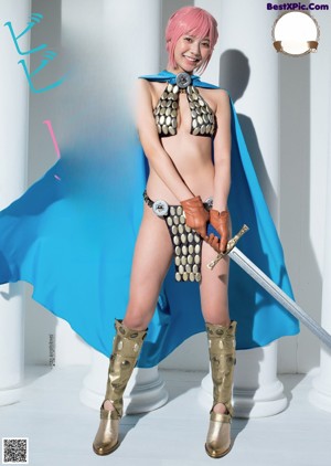 A woman in a bikini holding a sword and a blue cape.