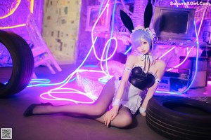 A woman dressed in a bunny costume posing for a picture.