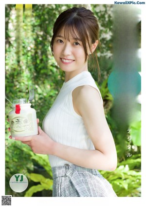 A magazine with a picture of a woman in a white top.