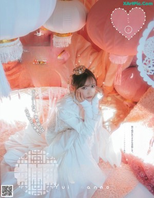 A magazine with a picture of a woman in a pink dress.