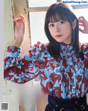 a woman in a purple shirt dress is posing for a magazine