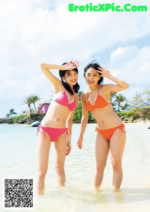 A group of young women standing next to a swimming pool.