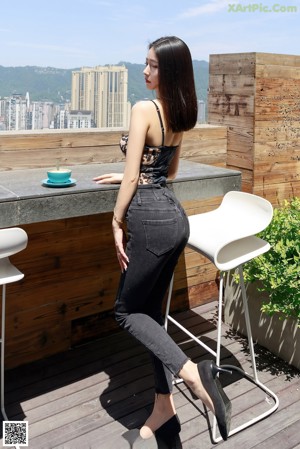 A woman sitting on the steps of a building with a cup of coffee.