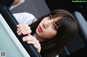 A woman in a school uniform holding a baseball bat.