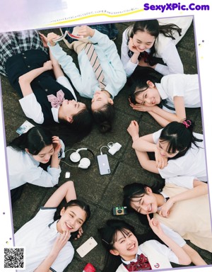 A group of young women in school uniforms posing for a picture.